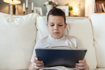 Caucasian boy, streaming and smartphone for educational games, growth and development in home. Kid, mobile tech and esports for creativity, fun and social media with application, download and playing.