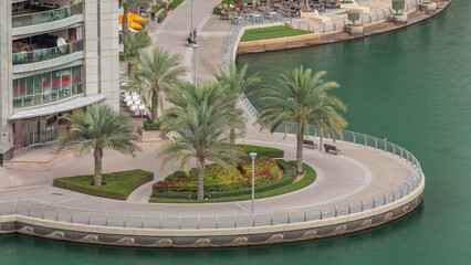 Waterfront promenade in Dubai Marina aerial timelapse. Dubai, United Arab Emirates