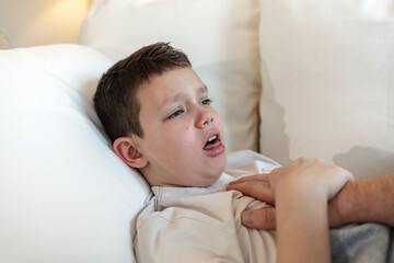 Home, bed and sick kid with hand of parent for high temperature or flu and ill at night. House, people and fever in bedroom with allergy, cold and virus or disease with care, support and trust.