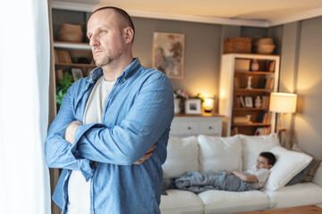 Worried father, sick boy and bed for healthcare, virus or infection in support or trust at home. Distraught dad, young kid or child with illness, flu symptom or cold fever, help or rest for nap.