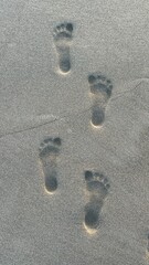 Footprints on Sandy Beach Surface