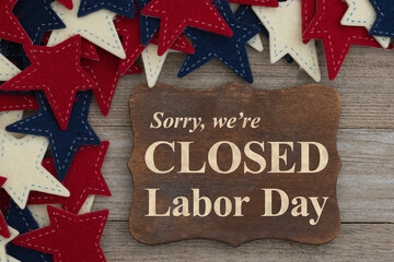 Closed Labor Day sign with retro USA red, white and blue star and stripes on wood sign