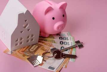 House, buying or selling real estate, concept background with money and piggy bank. Real estate
