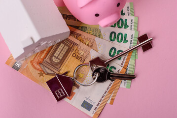 House, buying or selling real estate, concept background with money and piggy bank. Real estate