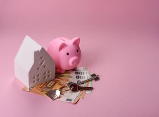 House, buying or selling real estate, concept background with money and piggy bank. Real estate