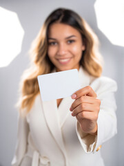 Woman holding credit card on a white backdrop