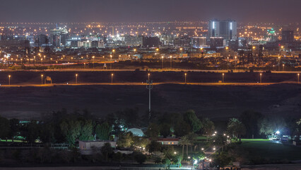 Fototapeta premium Aerial view to villas and houses near Golf course night timelapse