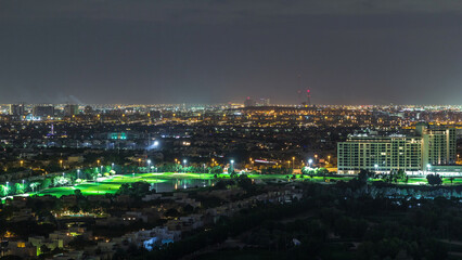 Aerial view to villas and houses with Golf course night timelapse