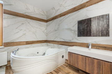 A modern hydro massage bath in the interior of a spacious bathroom with an exclusive design.