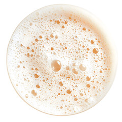 Close up aerial view of beer foam showing bubbles and texture in a round glass container
