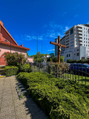 A missionary cross and an angel in front of the Roman Catholic Church of St. Martin in Kolobrzeg, Poland