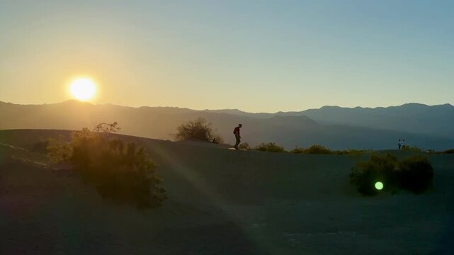 Silhouette of Hiker on Mesquite Flat Sand Dunes at Sunset Death Valley