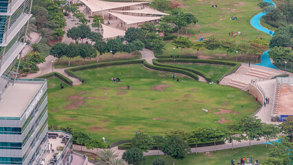 A landscaped public park in Jumeirah Lakes Towers timelapse, a popular residential district in...