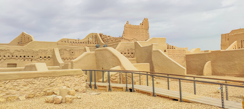 the expansive layout of Diriyah near Riyadh in Saudi Arabia, showcasing its distinctive mud-brick architecture and rich cultural heritage under a vibrant sky