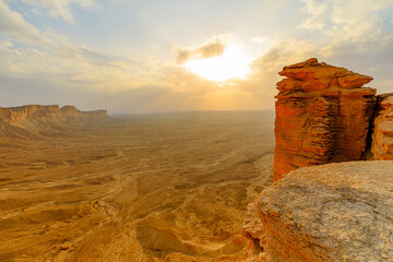 sunset on edge of the world rock formations at Jebel fihrayn near Riyadh, Saudi Arabia, create a...