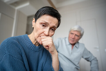 Shocked sad frightened mature woman feeling wronged by hysterical husband outburst. Emotional...