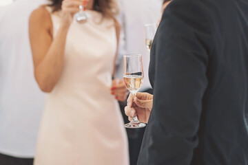 Elegant gathering features guests enjoying sparkling beverages amidst a lively atmosphere in a...