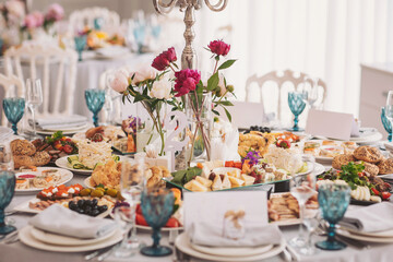 Elegant table set with a sumptuous feast for a memorable celebration featuring an array of delicious dishes and floral decorations