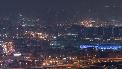 Aerial view of neighborhood Deira and Dubai creek with typical old and modern buildings night timelapse.