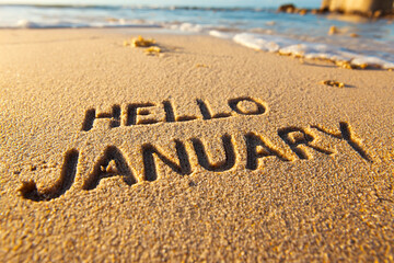 Fototapeta premium New Year Phrase HELLO JANUARY Written in Wet Beach Sand with Clean Bold Letters and Soft Texture for Calendar or Promo Use