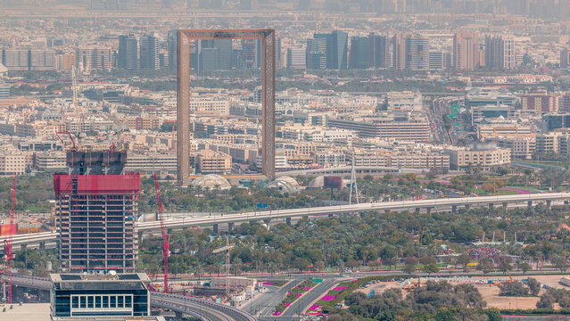 Aerial view to financial and zabeel district timelapse with traffic and under construction building with cranes from downtown