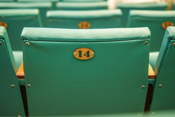 Teal theater seat with number plaque