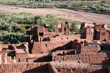 Aït Benhaddou, a traditional desert village in Morocco, featuring earthen clay houses and palm...