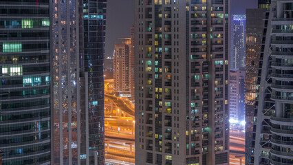 Residential and office buildings in Jumeirah lake towers district night timelapse in Dubai