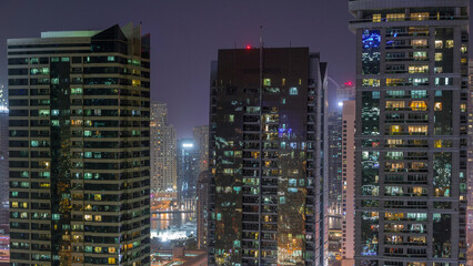 Obraz premium Residential and office buildings in Jumeirah lake towers district night timelapse in Dubai