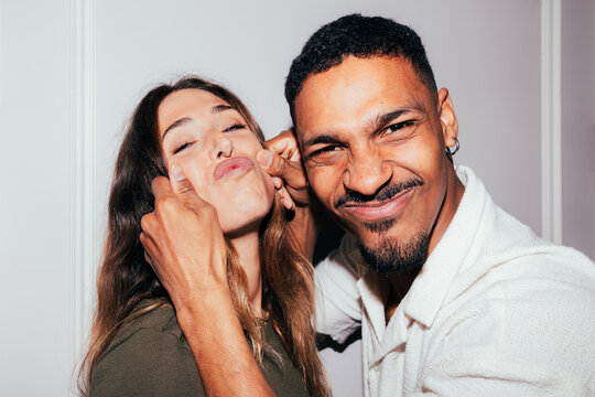 Playful couple making funny faces together