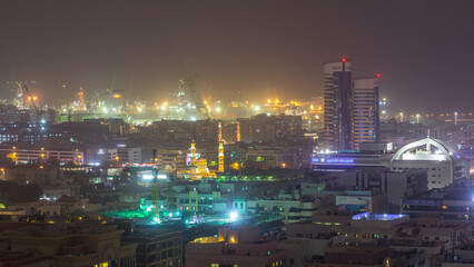 Aerial view over Port Rashid illuminated at night during sand storm timelapse in Dubai, United Arab Emirates