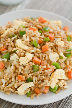 Homemade vegetarian fried rice made with onion, white cabbage, carrot, green pepper, soy sauce, oyster sauce, sesame oil and scrambled eggs (Selective Focus, Focus in the middle of the image)