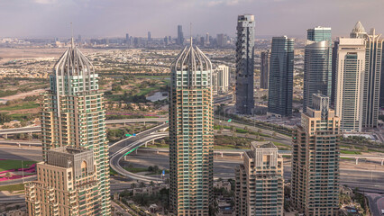 Fototapeta premium Dubai Marina skyscrapers and jumeirah lake towers view from the top aerial timelapse in the United Arab Emirates.