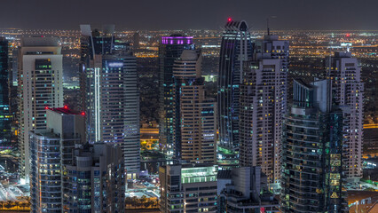 Dubai Marina skyscrapers and jumeirah lake towers view from the top aerial night timelapse in the...