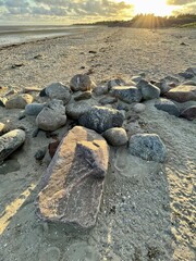 Stones arranged in a line against sunset on Foehr