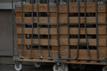 A sturdy wooden cart constructed with wheels and a durable metal frame, designed for easy transport...
