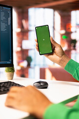Man enjoying leisure time at home, using green screen smartphone to text friends. Person talking...