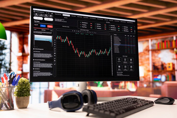 Computer screen in living room showing trading software interface used to buy and sell stocks....