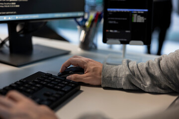 Data center admin typing on keyboard, developing disaster recovery plans. Close up of server hub...