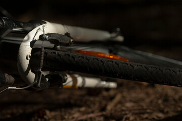 This is a detailed close up view of a bicycle tire alongside its brake component, highlighting...