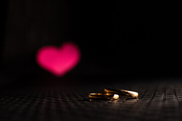 Wedding rings with a paper heart simulating marital love and commitment.