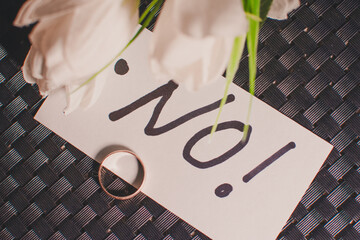 A paper with a wedding ring written 
