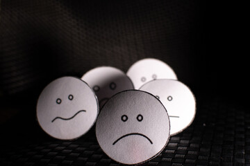 Round papers with emotional faces.