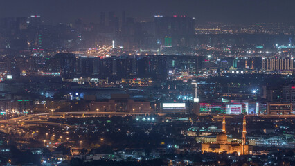 Aerial view of neighborhood Zabeel and Dubai creek with typical old and modern buildings night timelapse.