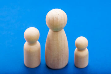 Wooden peg doll family on blue background