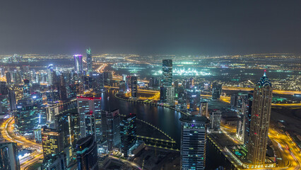Fototapeta premium Panoramic aerial view of business bay towers in Dubai night timelapse.