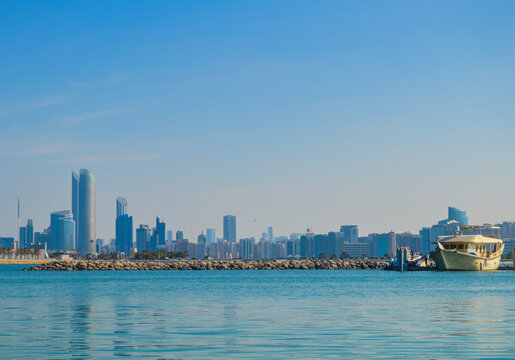 Fototapeta Abu Dhabi capital of UAE skyline along Corniche beach taken from a boat