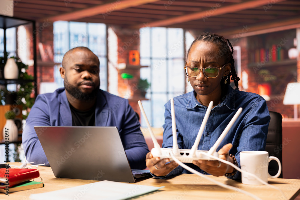 Poster black couple analyzing network problems and troubleshooting signal loss, adjusting their router plac