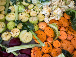 Colorful assortment of sliced vegetables ready for roasting — healthy meal prep background,...