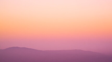Obraz premium Gentle Sunset over the Mountain Range with Soft Hues of Purple and Orange, Calming Scene
